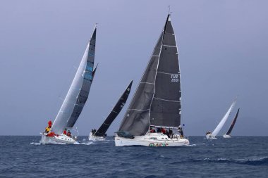 Bodrum, Hindi. 06 Nisan 2025: Ege Denizi 'nin mavi sularında, ünlü tatil beldesi Bodrum' un kıyılarında yelkenliler rüzgarlı havada yelken açıyor.