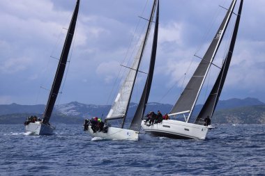 Bodrum, Hindi. 06 Nisan 2025: Ege Denizi 'nin mavi sularında, ünlü tatil beldesi Bodrum' un kıyılarında yelkenliler rüzgarlı havada yelken açıyor.