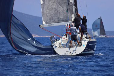 Bodrum, Hindi. 27 Nisan 2025: Ege Denizi 'nin mavi sularında, ünlü tatil beldesi Bodrum' un kıyılarında yelkenliler rüzgarlı havada yelken açıyor.