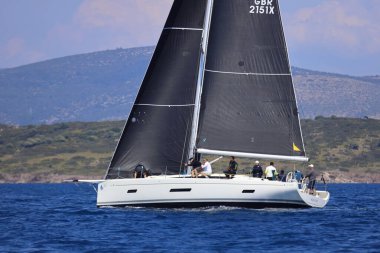 Bodrum, Hindi. 26 Nisan 2025: Yelkenliler Ege Denizi 'nin mavi sularında, ünlü tatil beldesi Bodrum' un kıyılarında rüzgarlı havada yelken açıyor..