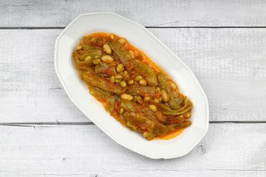 Homemade stewed green beans, tomatoes, garlic with olive oil. Zeytinyagli fasulye traditional food. Turkish cuisine.