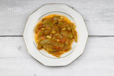 Homemade stewed green beans, tomatoes, garlic with olive oil. Zeytinyagli fasulye traditional food. Turkish cuisine.