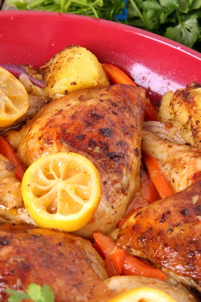 Tender oven baked chicken thighs with lemon roasted carrots. Nutrious and budget friendly dinner. Simple roasted chicken meal.