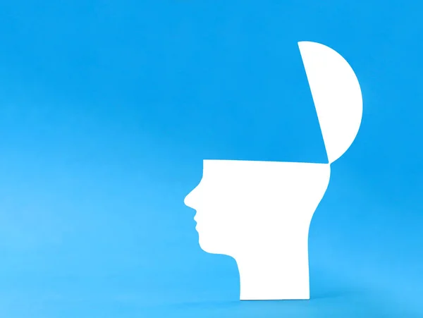 open white male head silhouette on blue background with copy space, feed the head with knowledge.