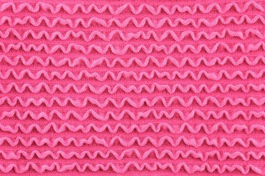 Dalgalı pembe kumaş dokusu, tekstil arka planının soyut dokusu..