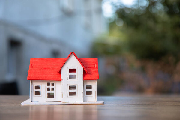 Model of a wooden house on a wooden tabl