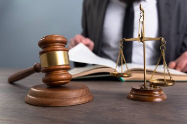 Yargılama, çekiç ve terazinin önünde kitap okur. Mahkeme salonu.