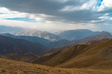Dry mountain peaks under the cloud
