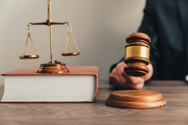 JUDGE Strikes with gavel. scales of justic