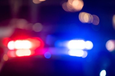 Gece yarısı yanıp sönen ışıkları olan polis arabası.