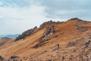 Dry mountain peaks under the cloud