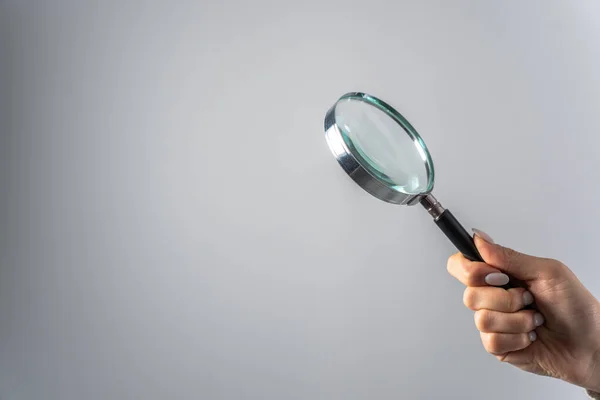Young Woman Holding Magnifier Gray Backgroun — Stock Photo, Image