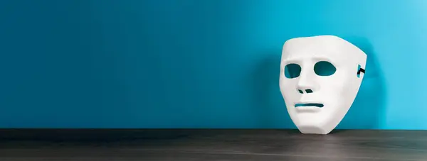 White anonymous mask on the tabl