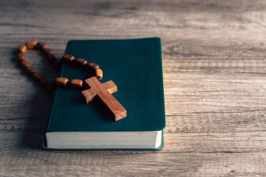 Cross and bible on a wooden table