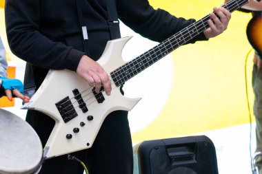 Bir adam sokakta elektro gitar çalıyor.