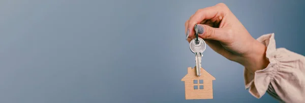 Agent holding house keys. Real estate concep