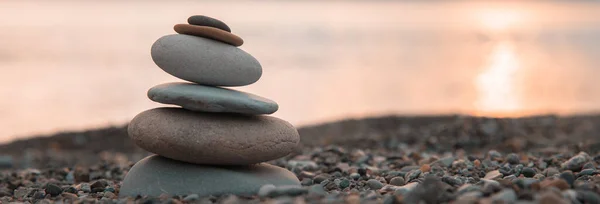 Zen stones on the sea beach at sunse