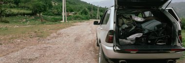 Open trunk of car with travel item