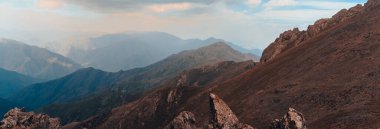 Dry mountain peaks under the cloud