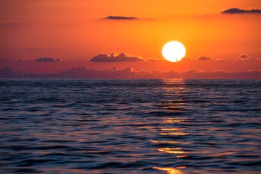 Gün batımında güzel bir deniz, doğal bir resim, denize düşen güneş ışığı.