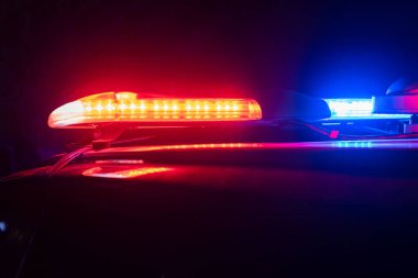 Red and blue lights of a police car at night close up. stock photo clipart