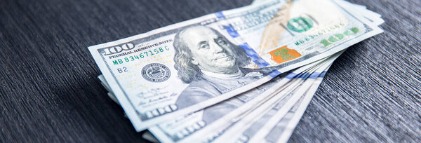 Stack of hundred dollars on the tabl