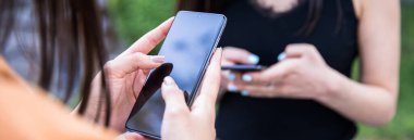 Stree 'de akıllı telefonla etkileşime geçen iki kadın.