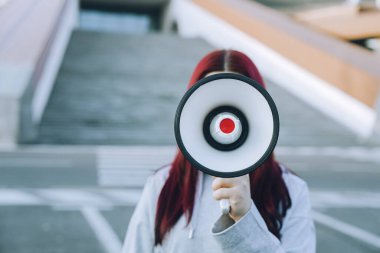 Woman holding a loudspeaker, protest, announcement clipart