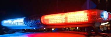 Polis arabasının tepesinde kırmızı ışık yanıp sönüyor..