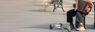 Sokak müzisyeni akordeon çalar ve para ister