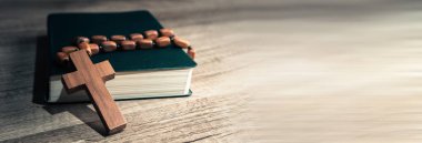 Cross and bible on a wooden table