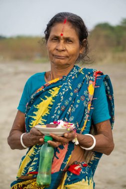 Gorai-Madhumati river of Bangladesh. An old woman is going to the river with puja offerings by the river. River nature scene of Bangladesh. The scene was captured on 24 October 2023 from Rajbari, Bangladesh. clipart