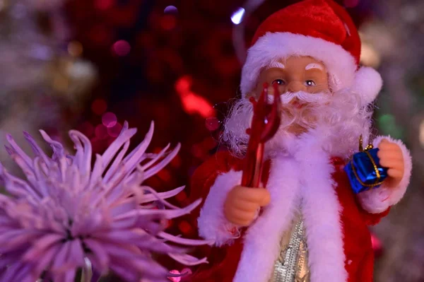 stock image christmas santa claus with red hat and beautiful flower