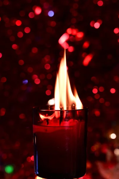 stock image burning candles on red blurred bokeh background