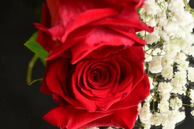 beautiful  spring  flowers composition   with roses   on black background