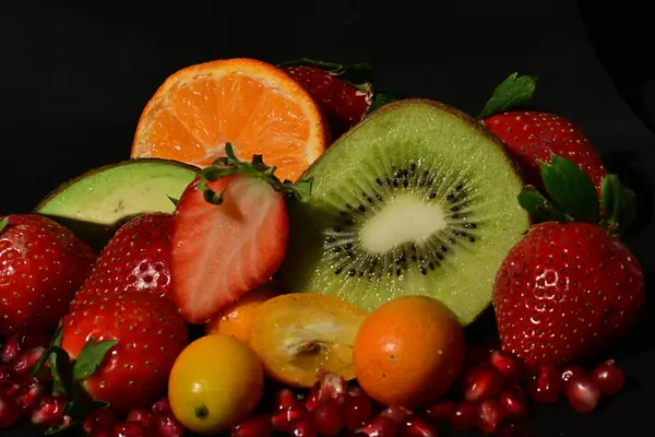 assortment of fruits and vegetables on a black background