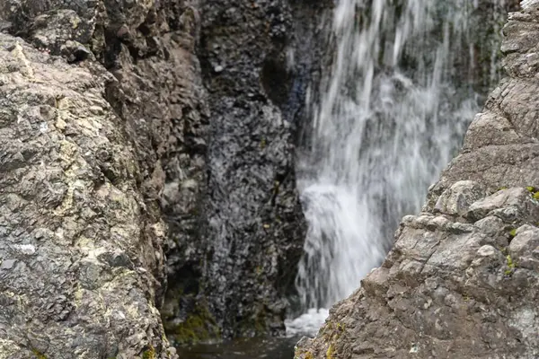 Dağlardaki güzel şelalenin manzarasını kapat.