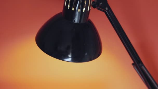 Turning Black Office Lamp Orange Background Dark Interior — ストック動画