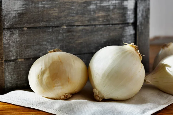 stock image Fresh white onions in wooden table , agricultural occupation