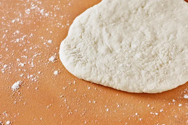 Hamur hamuru pişirmeden önce masaya konur, yemek hazırlar.