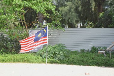  Malaysia flag on sandy beach. clipart