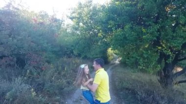 Happy father and daughter child play in summer park. The guy throws the girl up and catches