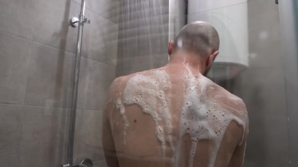 Back View Young Bald Caucasian Man Takes Shower Foaming Sponge — Stockvideo