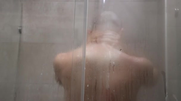 Back View Young Bald Caucasian Man Takes Hot Shower Defocused — Wideo stockowe