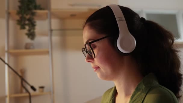 Close Pretty Caucasian Woman Wearing Glasses Headphones Works Online Side — Video