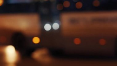 Bright lights of vehicles. Background with blurred night city road with traffic. Urban life.