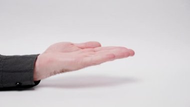 International Anti-Corruption Day. Woman count out money while man is impatiently waiting for payment. Close-up of hands on white background. Concept of bribery and investment.