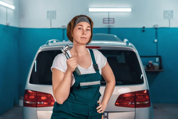 Young Serious Woman Mechanic Overall Holding Wrench Background Car Auto — Foto Stock