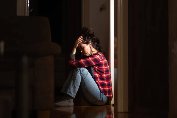うつ病や精神障害 若い白人女性は絶望の中床に座っている サイドビュー 暗いリビングルーム 心理学の問題の概念 — ストック写真