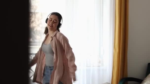 Feliz Joven Caucásica Mujer Desinhibida Con Auriculares Disfrutando Bailando Ventana — Vídeos de Stock